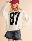 Aemi+Co Contrast Number Cable Knit Drop Shoulder Sweater